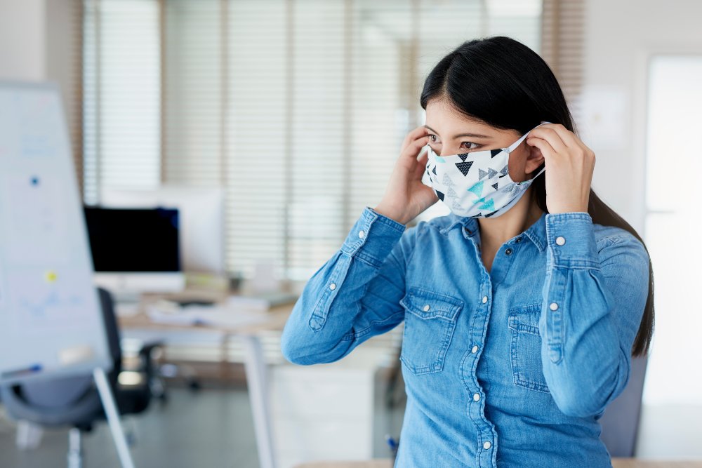 Woman wearing face mask in the office