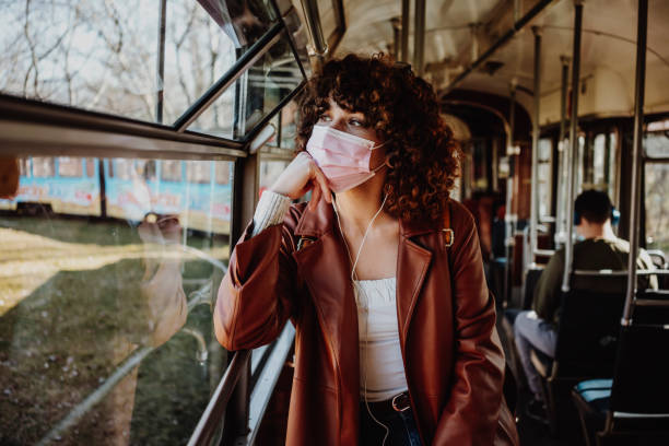 Young woman in public transportation during the pandemic