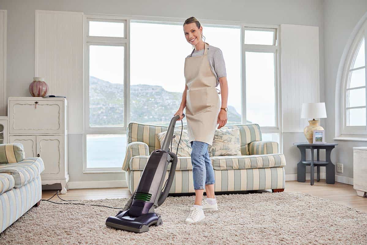 woman-vacuuming-carpet-at-home
