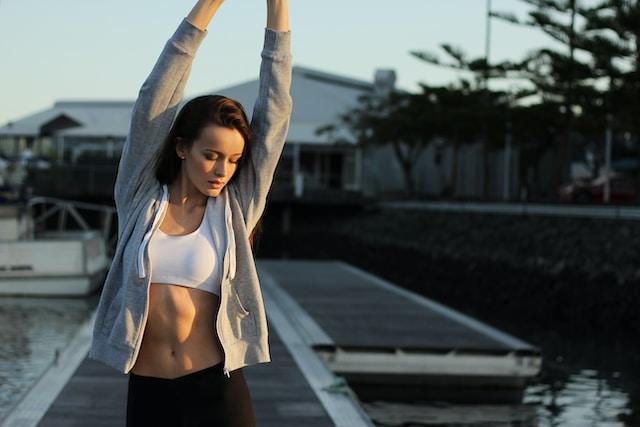 woman in sportswear stretching outdoors